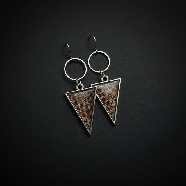 Triangle earrings featuring ethically sourced snake shed