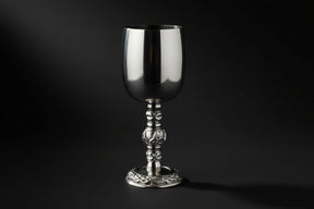 Silver goblet with intricate design on a white background