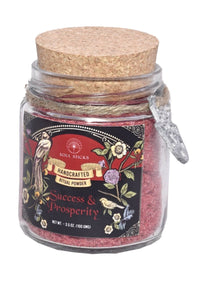 Jar of 'Success & Prosperity' powder with decorative label on a white background