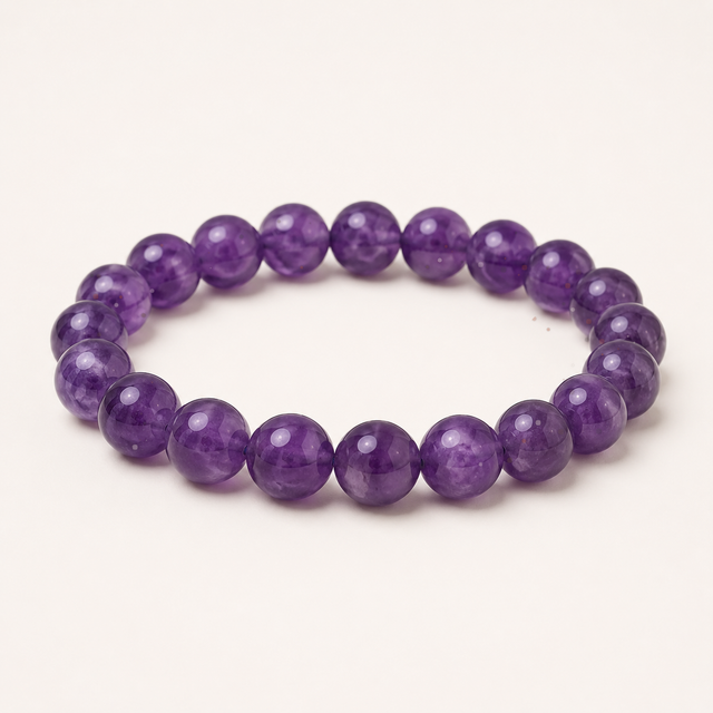 Polished round Super 7 beaded stretch bracelet with purple, clear, smoky, and iron-rich inclusions.