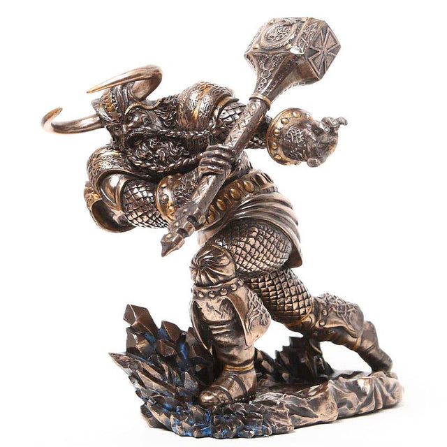 Decorative figurine of a warrior holding a large weapon on a white background