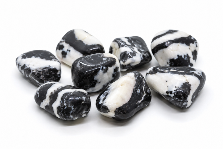 Assortment of polished Tiger Calcite stones with black, white, and cream banding on white
