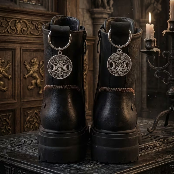 Pair of silver-tone Triple Moon Boot Charms with central pentacle motif on black boots