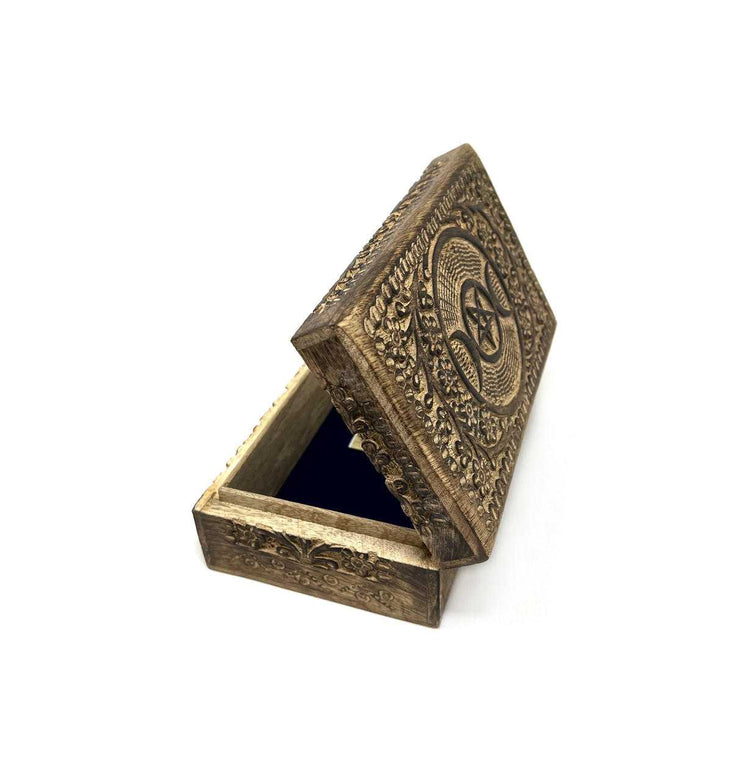 Decorative bronze box with intricate designs on a white background