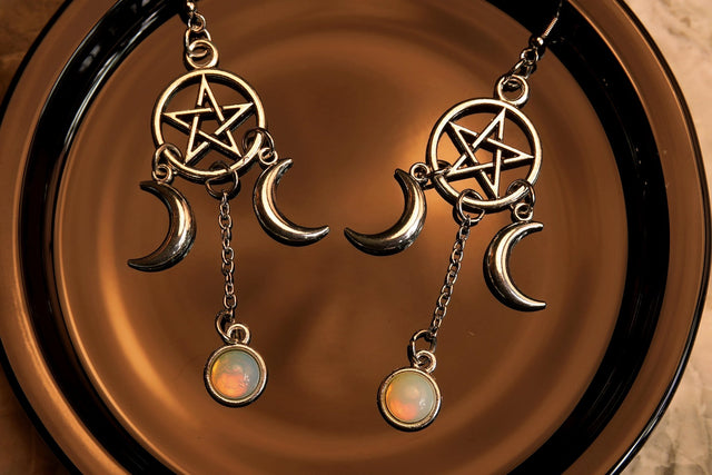 triple moon pentacle earrings sillver on a black background