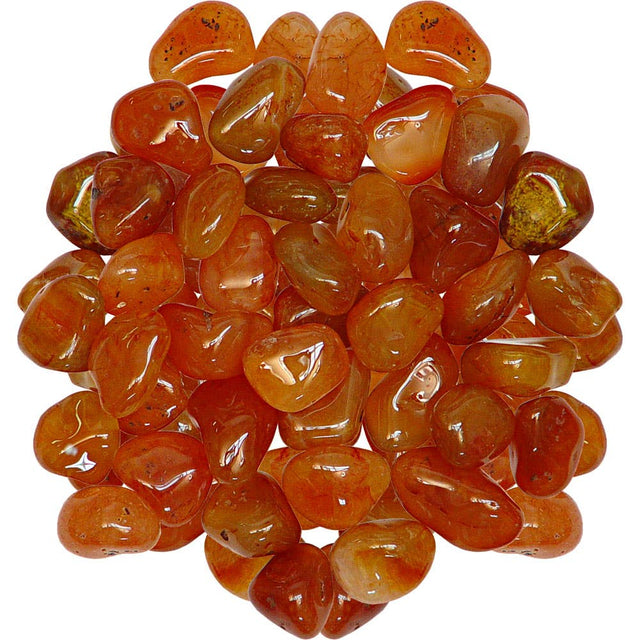 Collection of orange and red tumbled carnelian stones on a white background