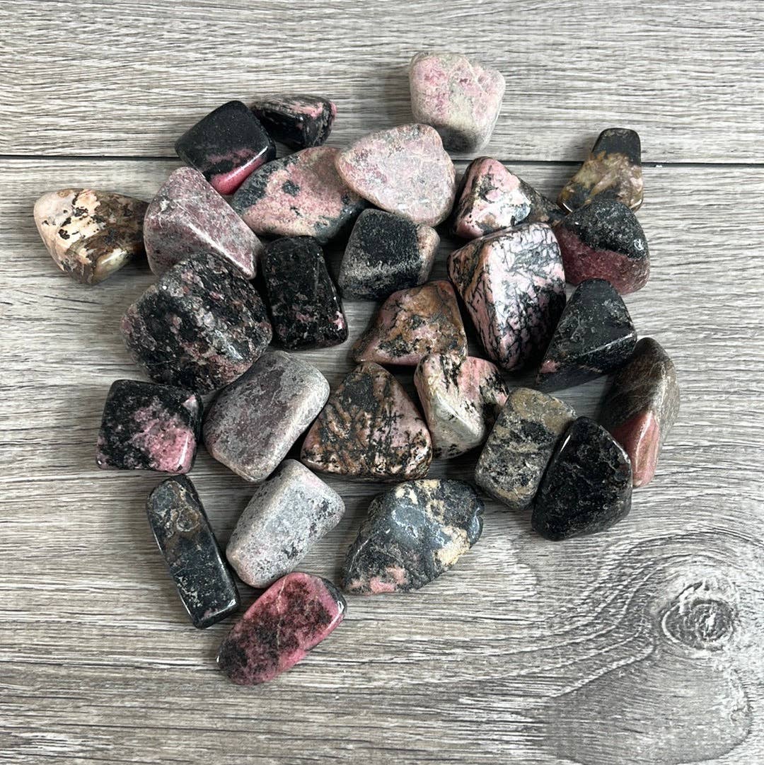 Collection of multicolored stones on a wooden surface