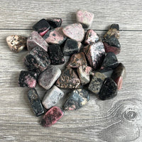 Collection of multicolored stones on a wooden surface
