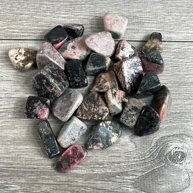 Collection of multicolored stones on a wooden surface