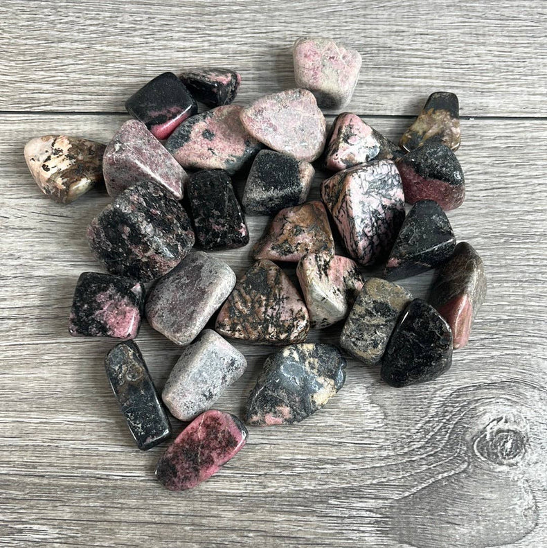 Collection of multicolored stones on a wooden surface