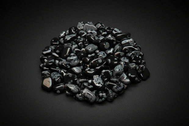Polished black Snowflake Obsidian stones with white-to-gray patterns