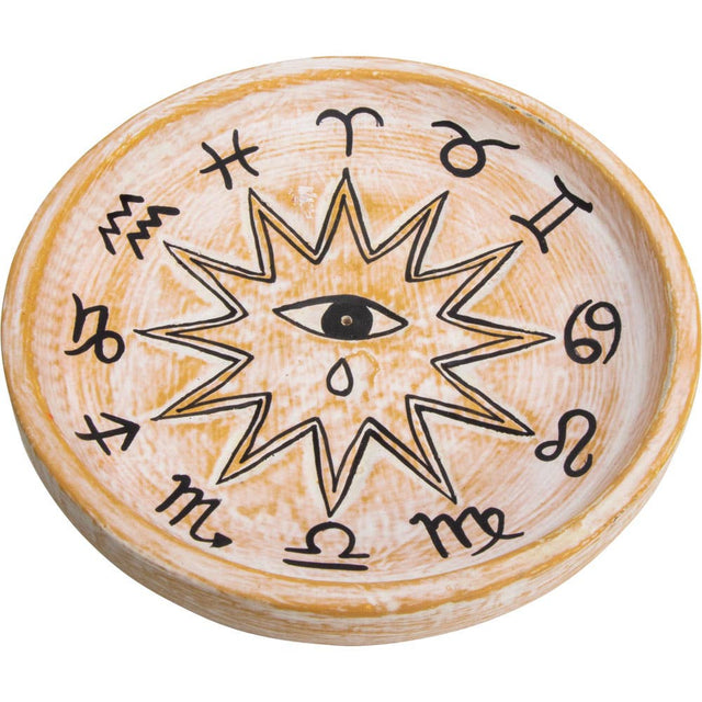Wooden disc with astrological symbols and an eye design on a white background
