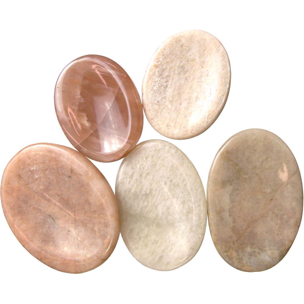 Five polished stones of different colors on a white background
