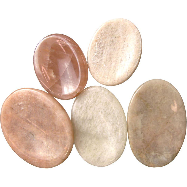 Five polished stones of different colors on a white background