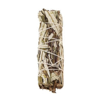 Bundle of sage sticks tied with white string on a white background