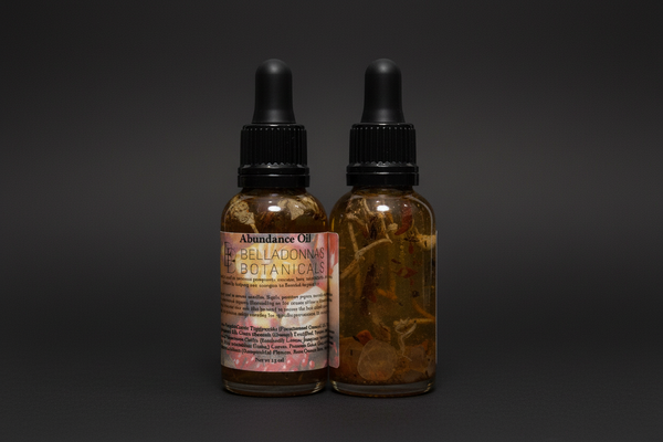 Two glass bottles with droppers labeled 'Abundance Oil' from Belladonna Botanicals on a white background.